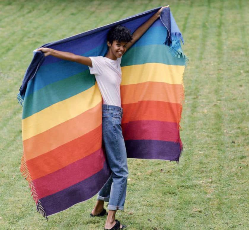 Une femme qui porte un grand tissu avec plusieurs couleurs